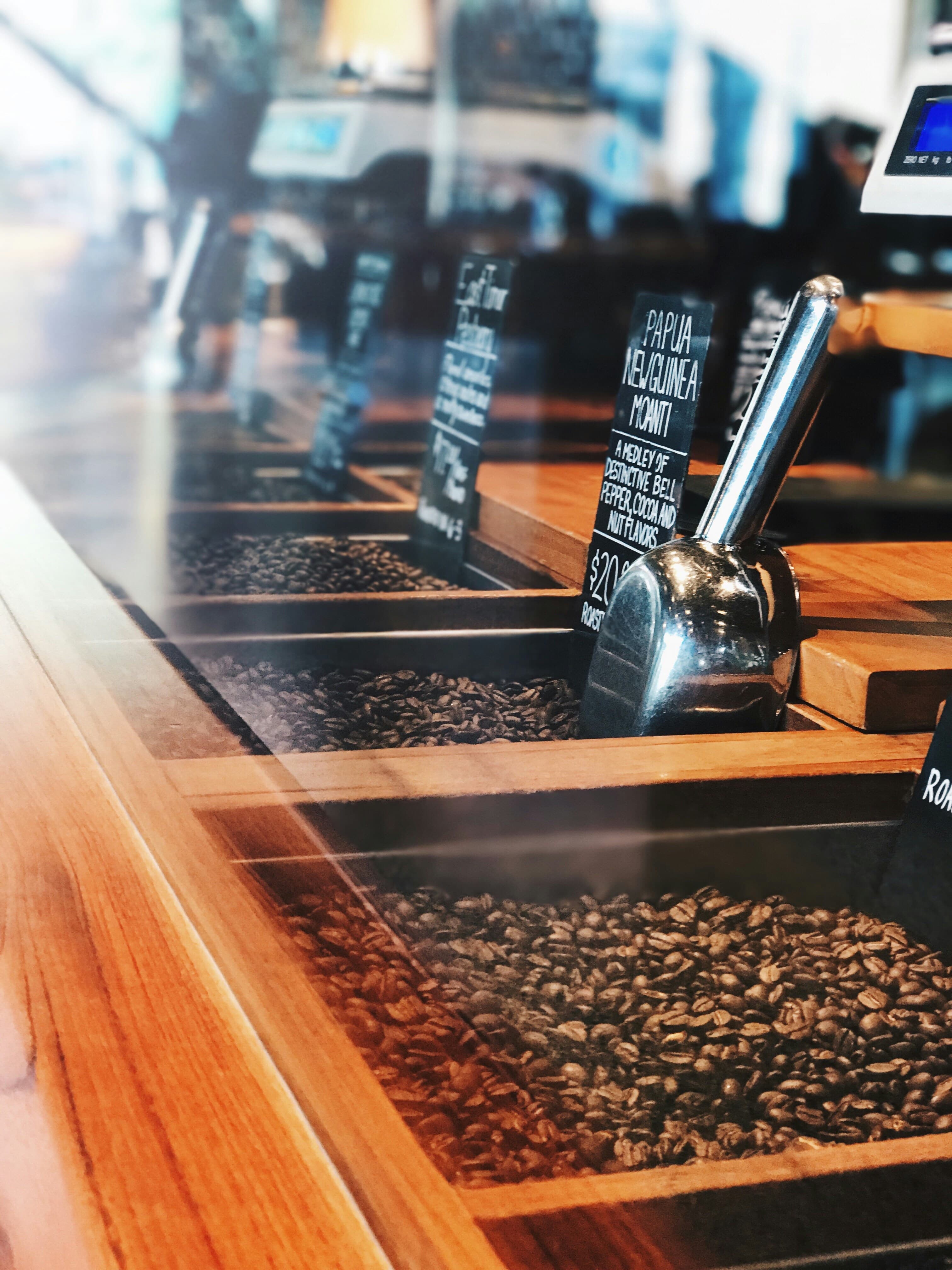 A hand selecting coffee before a guided choice.